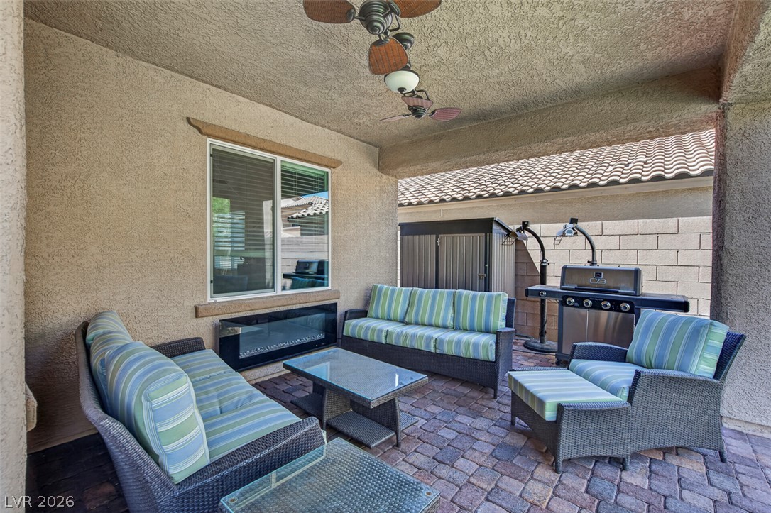 1824 Redland Ridge Street Henderson, NV 89002 - Photo 61 of 69 An inviting outdoor living space features a built-in electric fireplace and convenient grill.