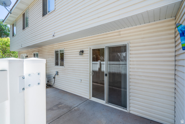 1735 West 540 North, Unit 1805 St. George, UT 84770 - Photo 31 of 64 Concrete patio with sliding glass door entry, surrounded by horizontal siding
