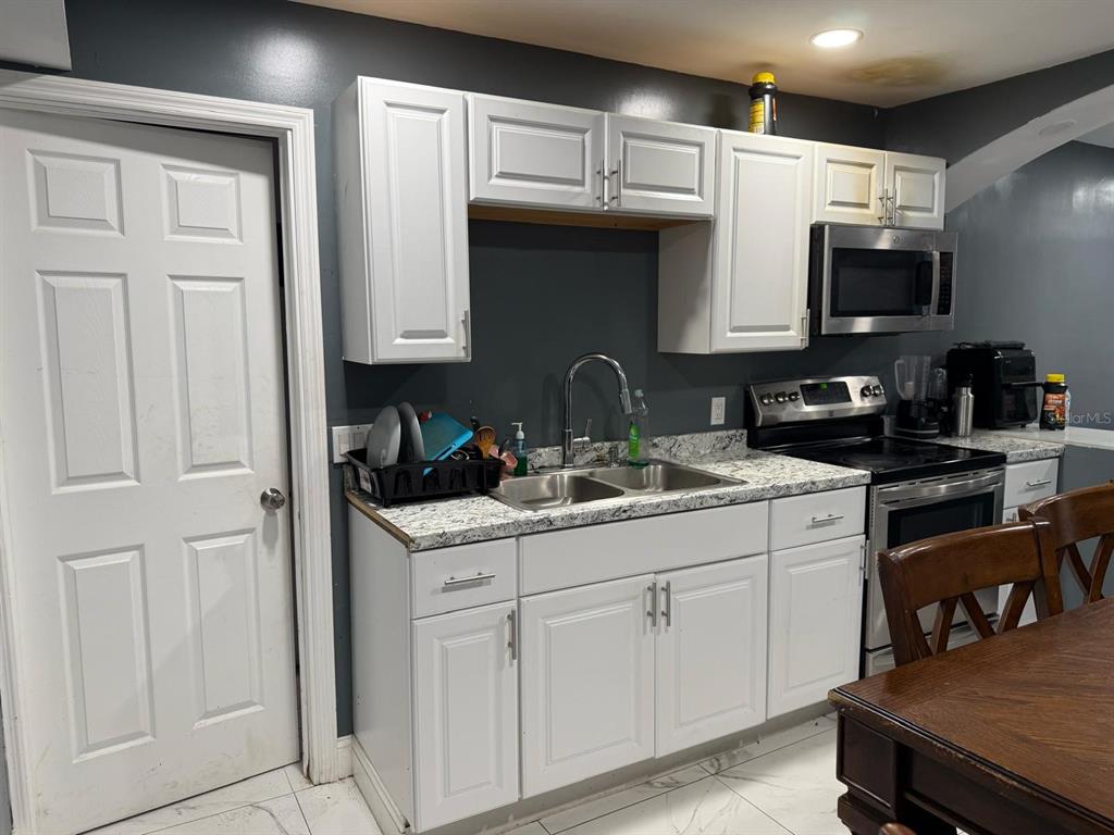 414 Spring Avenue Arcadia, FL 34266 - Photo 17 of 36 a kitchen with stainless steel appliances granite countertop a sink a stove and cabinets