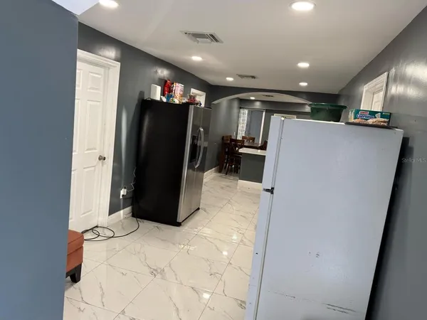 a view of a hallway with furniture