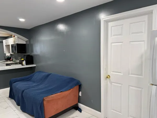 a room with a bed and a television