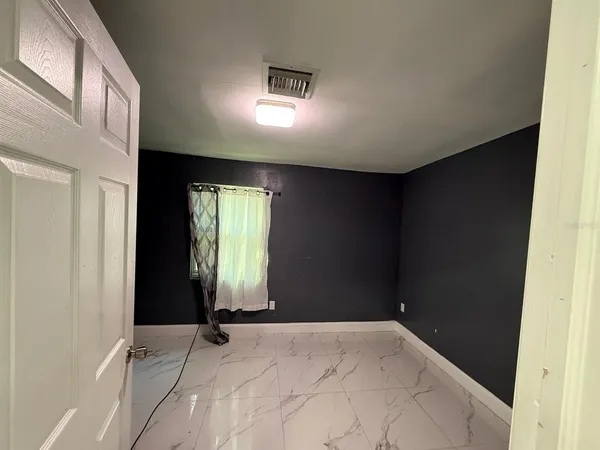 a view of an empty room and window