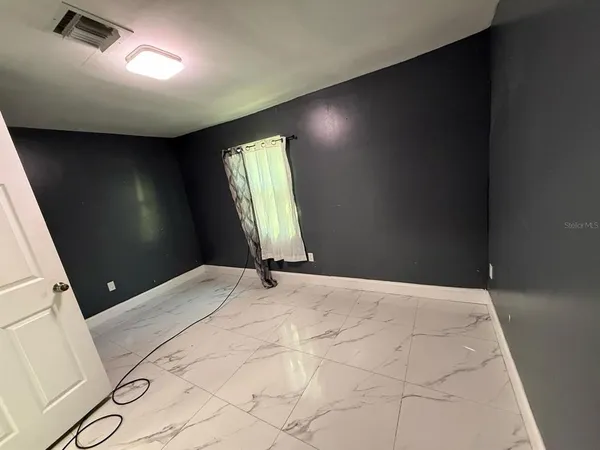 a view of an empty room and window