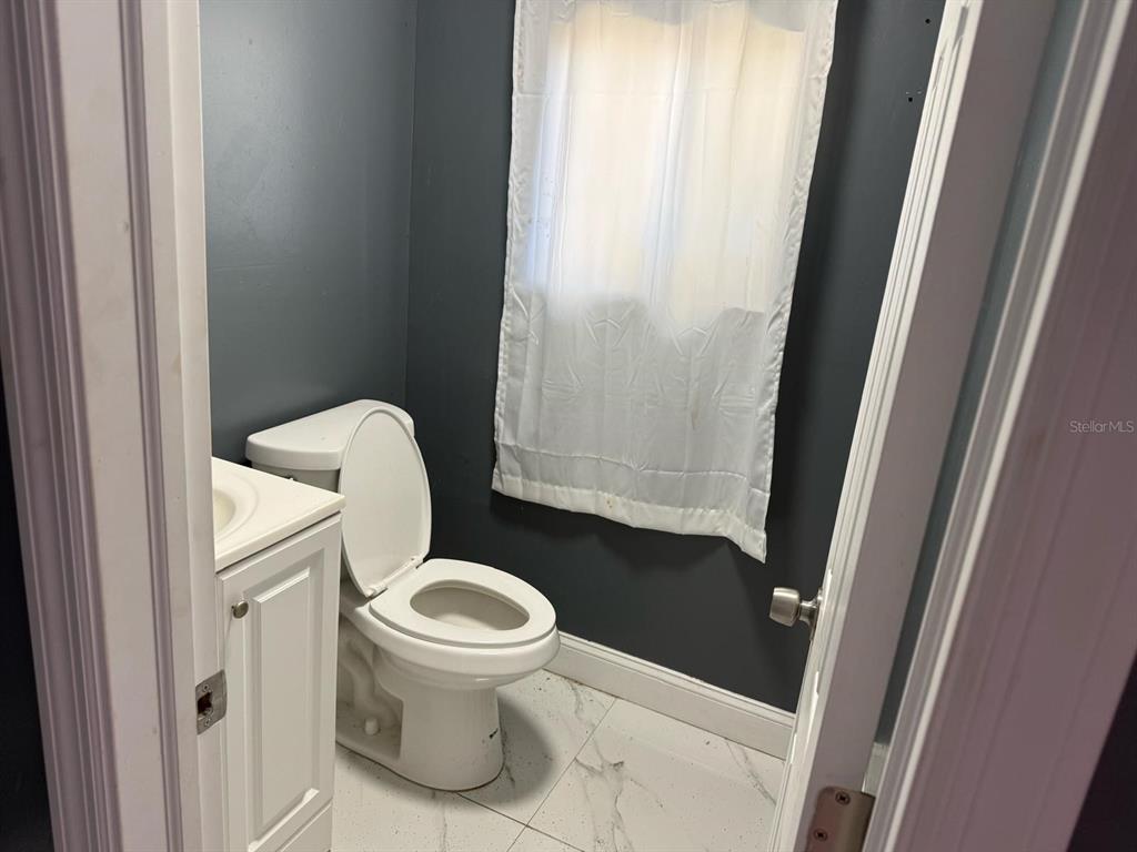 414 Spring Avenue Arcadia, FL 34266 - Photo 30 of 36 a white toilet sitting in a bathroom next to a sink