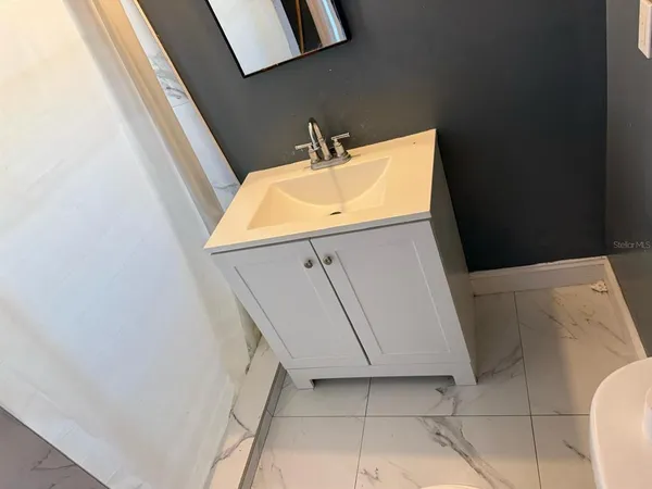 a bathroom with a sink and vanity