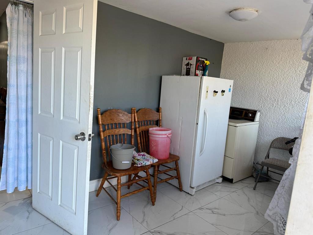 414 Spring Avenue Arcadia, FL 34266 - Photo 34 of 36 a room with furniture and a refrigerator