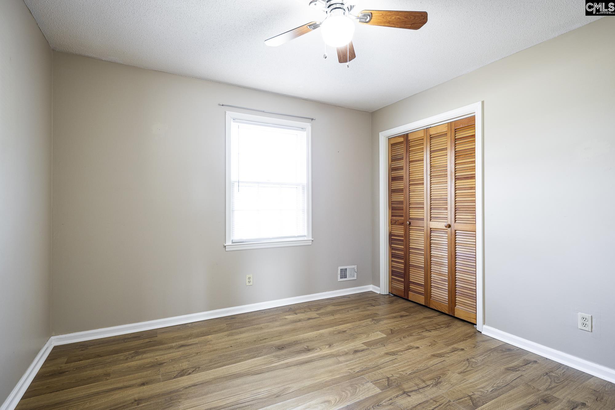 4083 Platt Springs Road West Columbia, SC 29170 - Photo 17 of 35 an empty room with wooden floor and windows