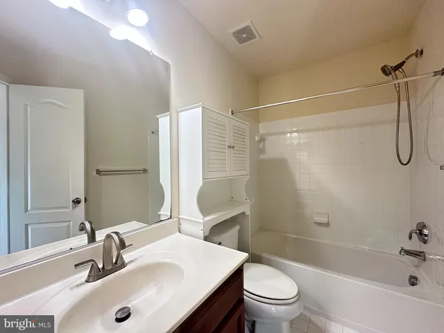 a bathroom with a sink toilet tub and shower