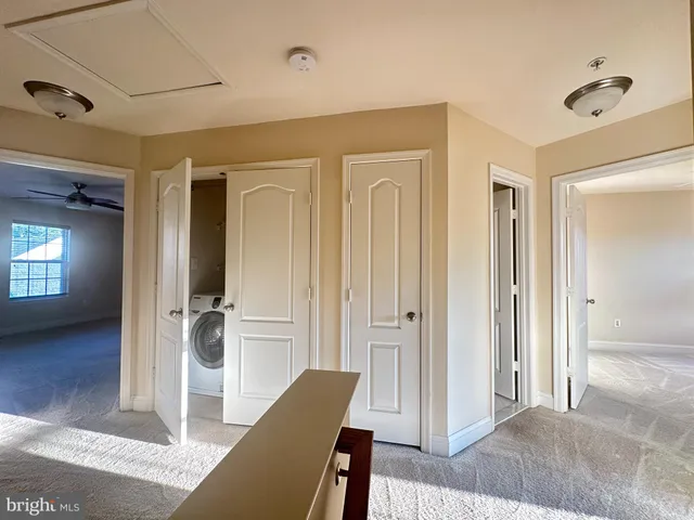 a view of a hallway with furniture and wooden floor