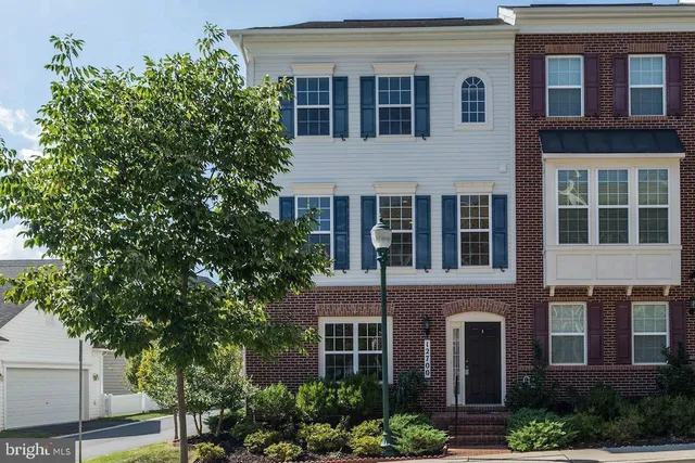 a view of a brick building next to a yard
