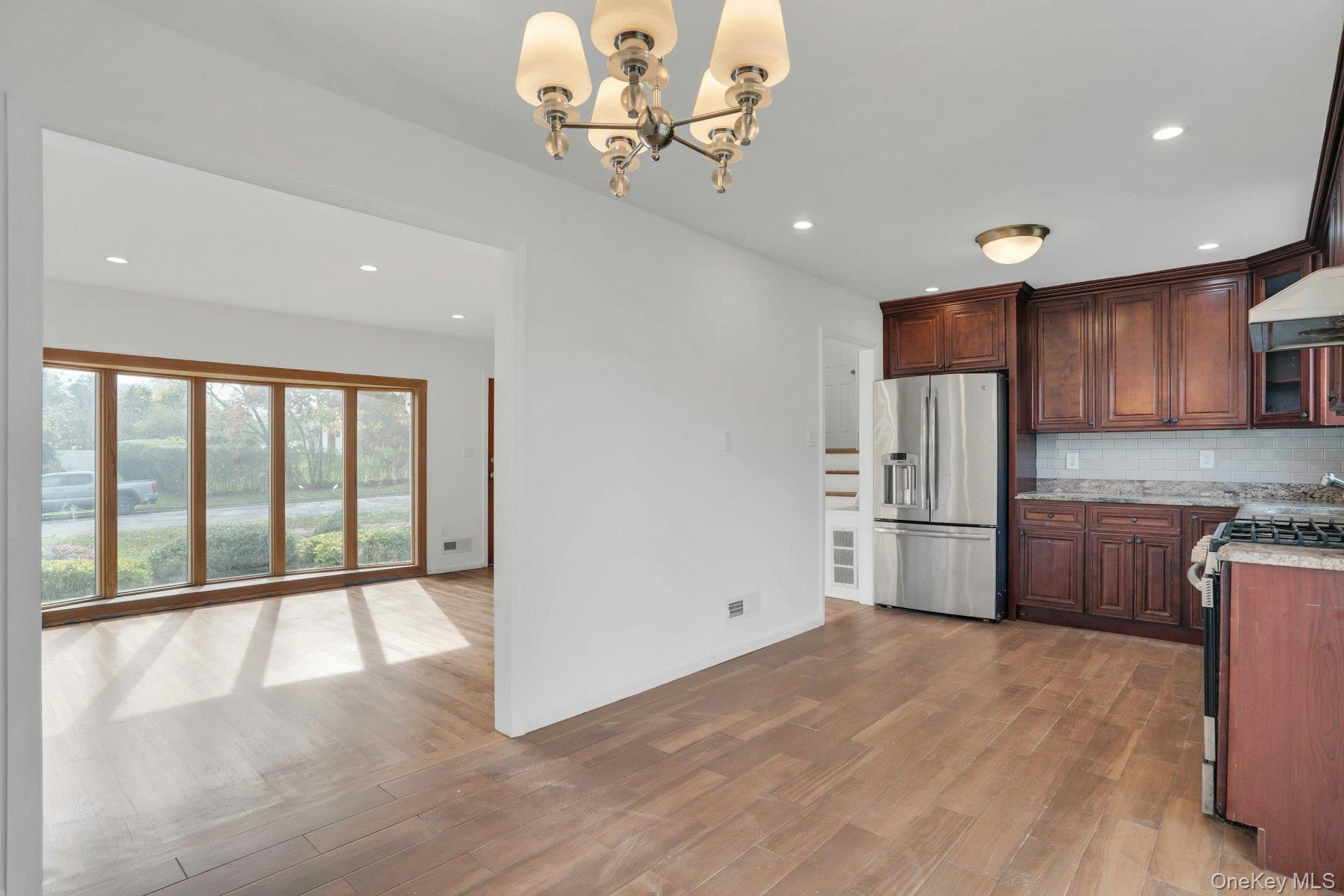 44 Delaware Avenue Commack, NY 11725 - Photo 11 of 34 a view of a kitchen with a sink and refrigerator
