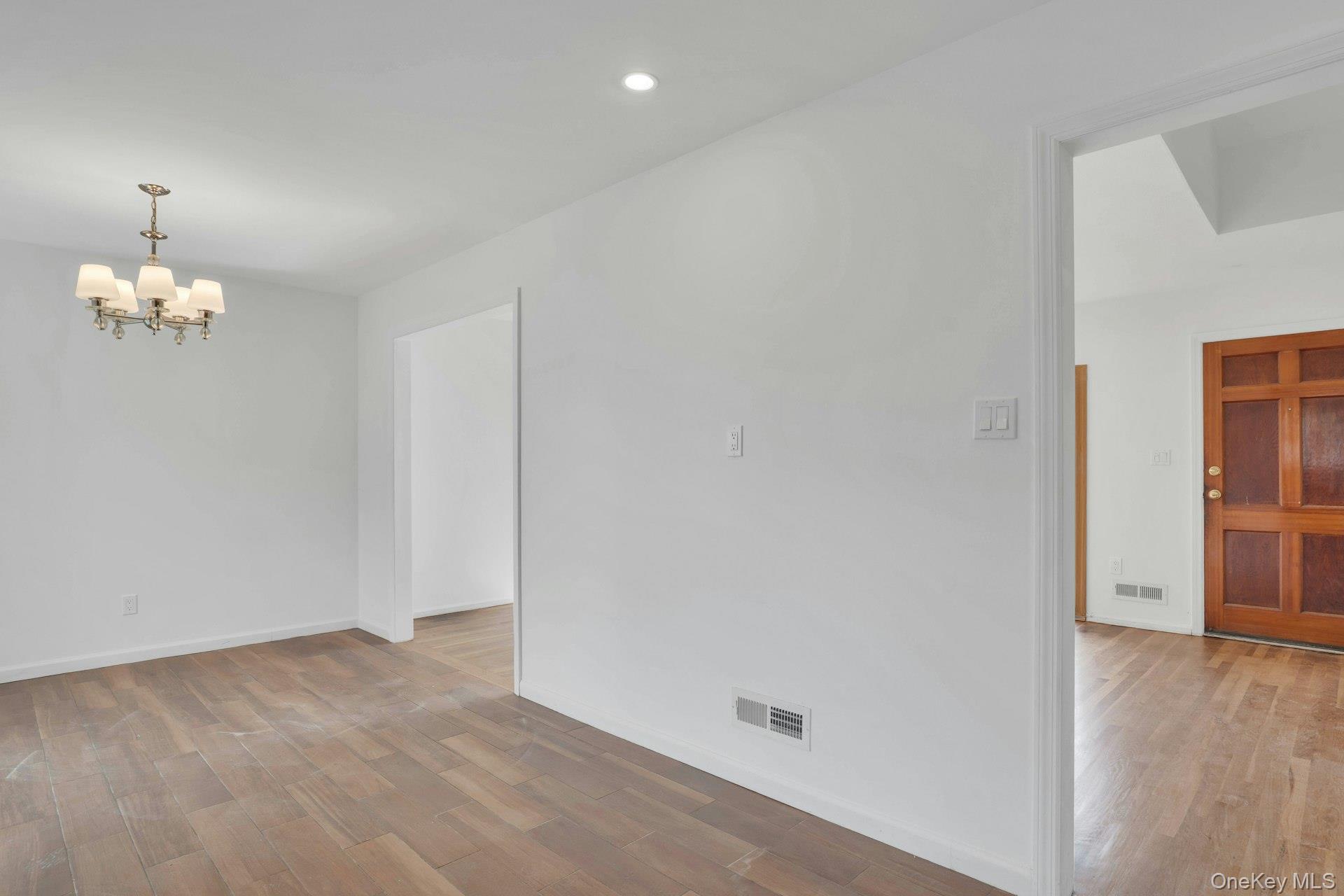 44 Delaware Avenue Commack, NY 11725 - Photo 13 of 34 wooden floor in an empty room with a window