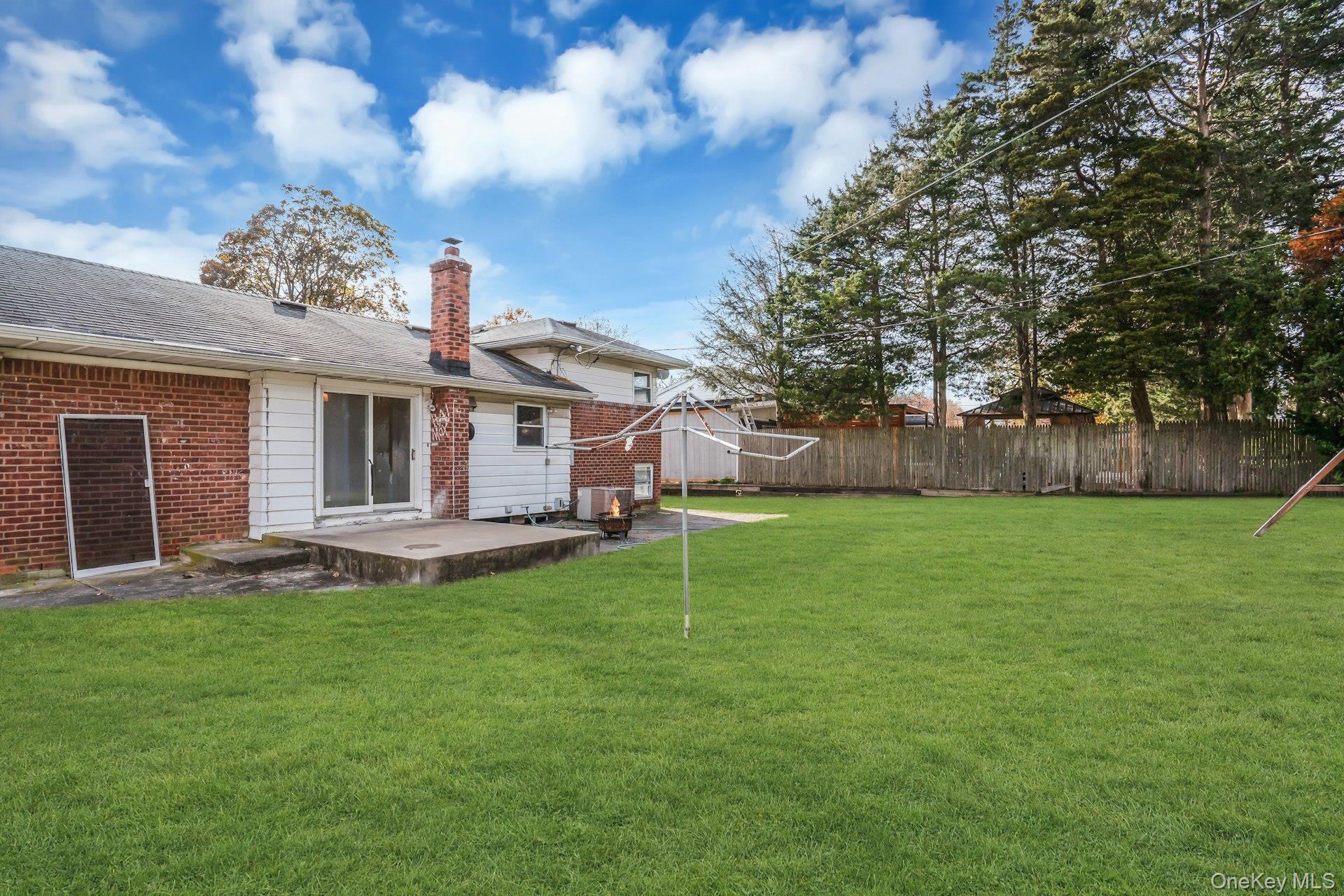 44 Delaware Avenue Commack, NY 11725 - Photo 32 of 34 a view of a house with a yard and sitting area