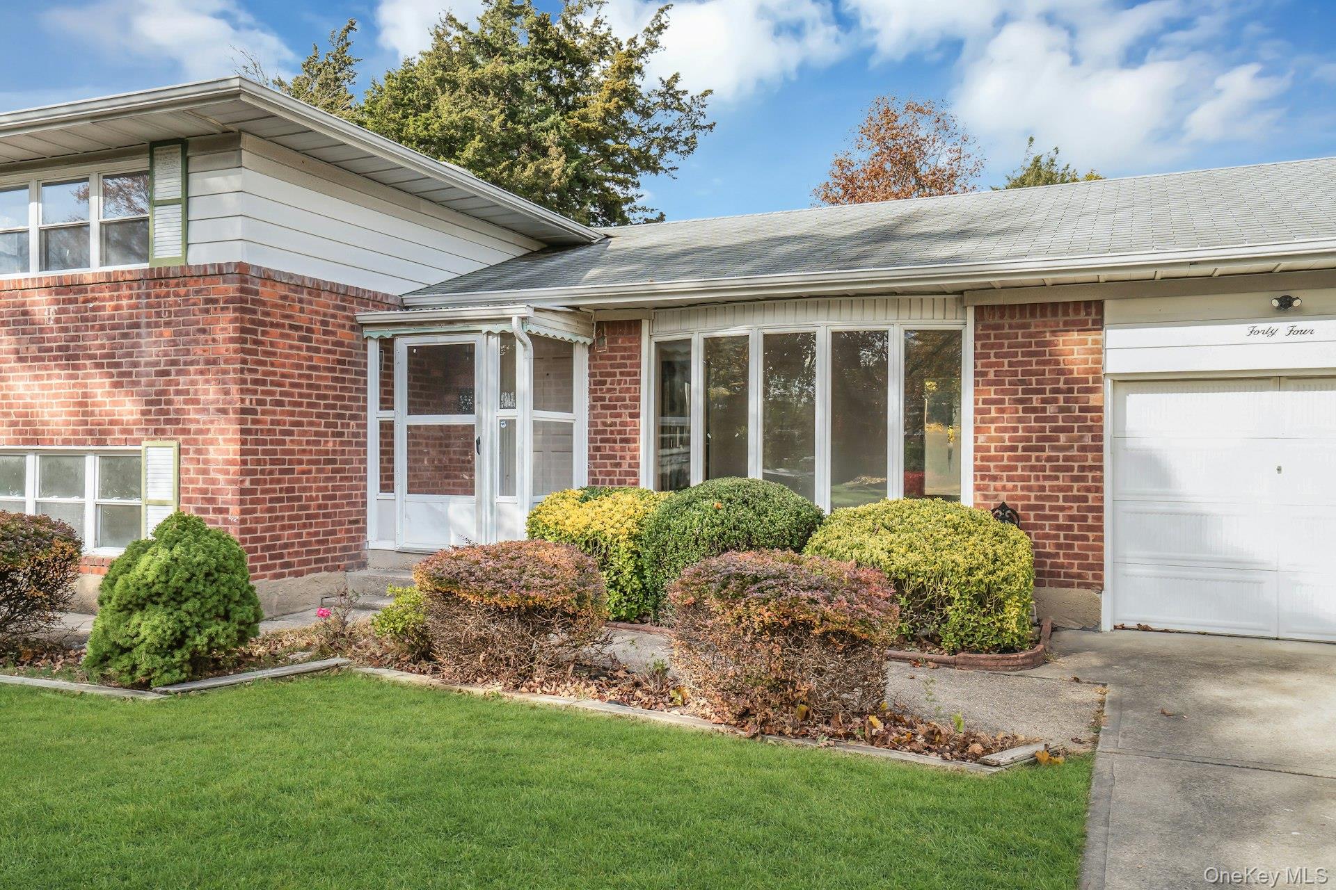 44 Delaware Avenue Commack, NY 11725 - Photo 5 of 34 a view of a house with a garden