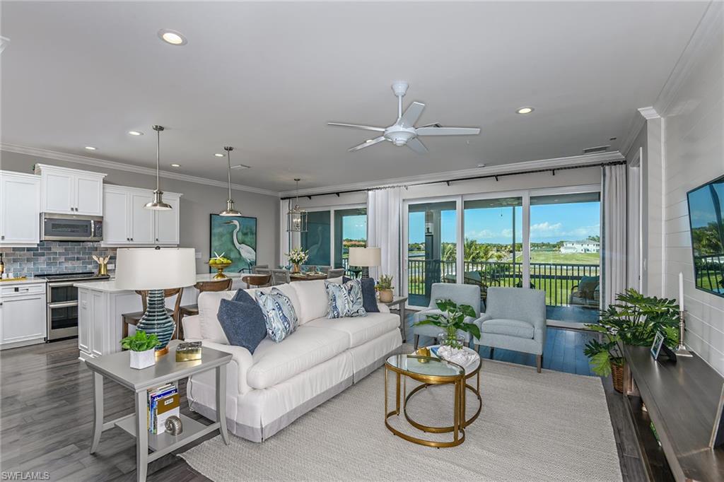 2603 Seychelles Circle, Unit 1507 Naples, FL 34112 - Photo 4 of 25 a living room with furniture and a large window