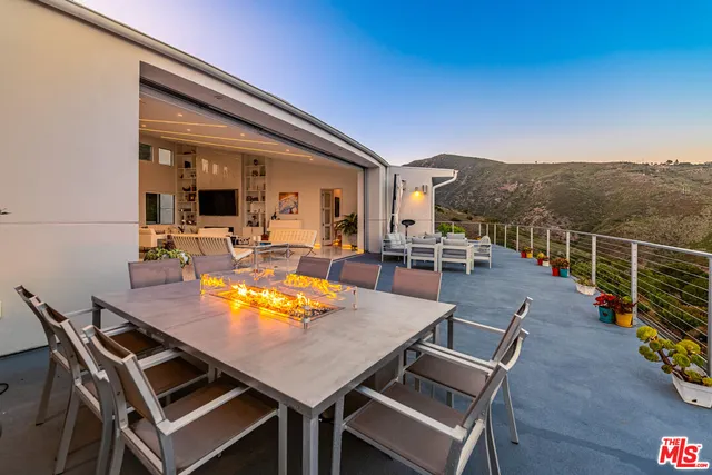 a large bedroom with a bed and glass windows