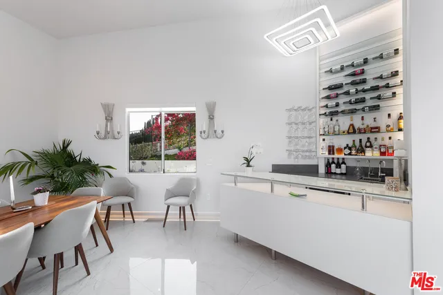 a view of a patio with couches and table and chairs with wooden fence