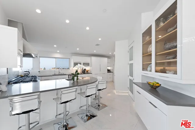 a view of kitchen with furniture and refrigerator