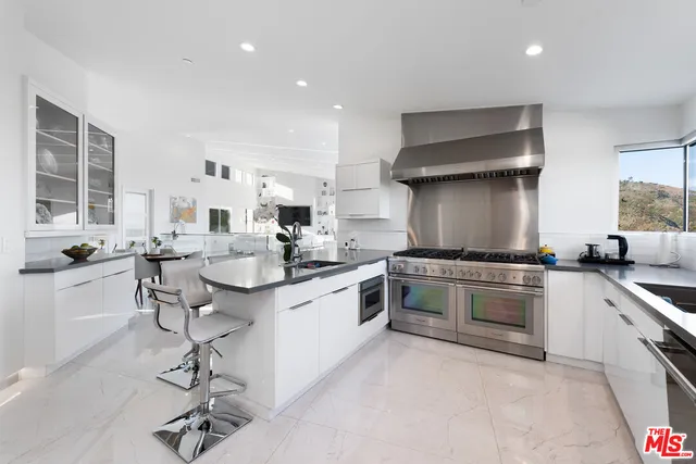 a kitchen with stainless steel appliances a stove a microwave and a refrigerator