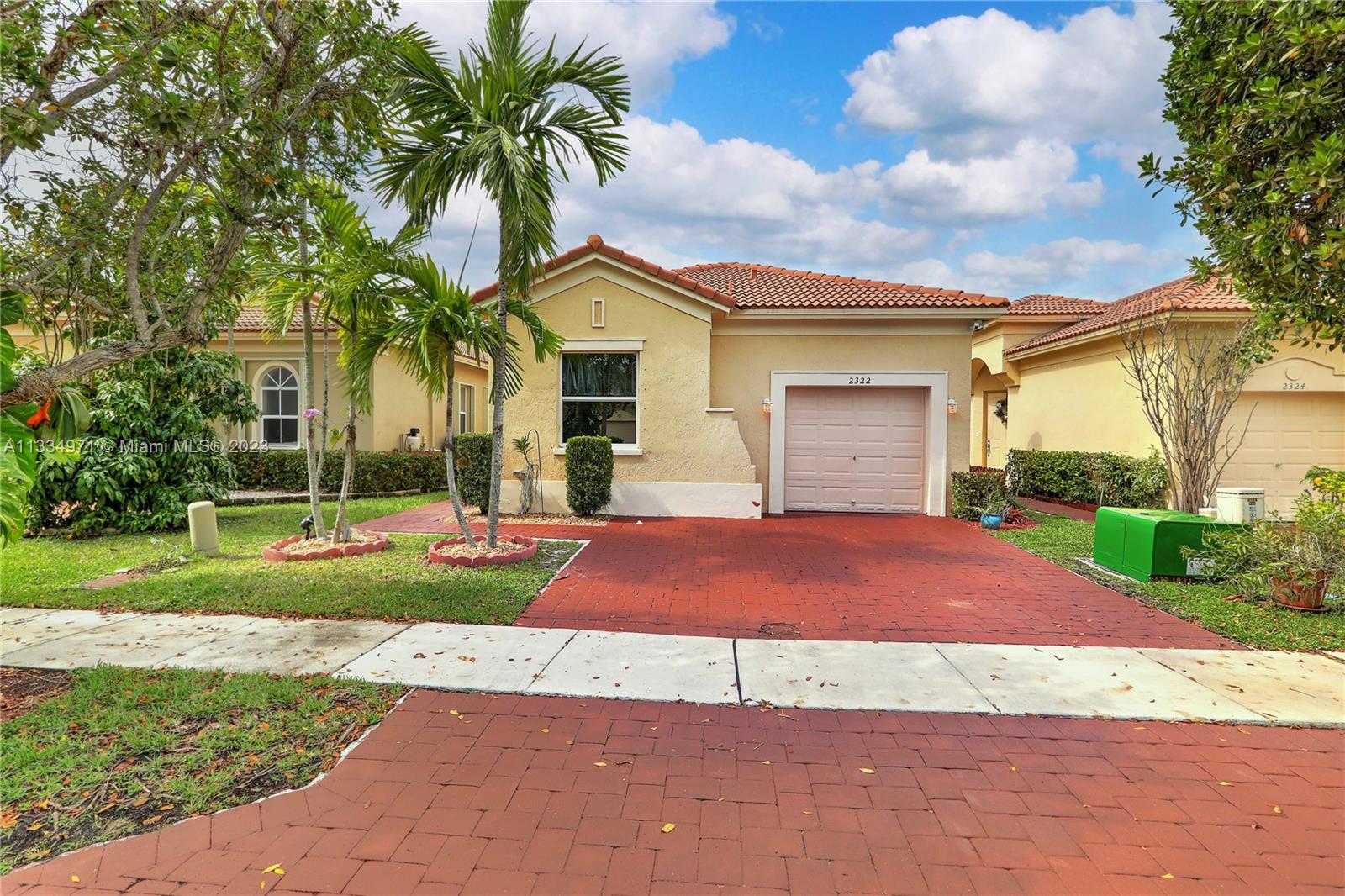 a front view of a house with yard and garage
