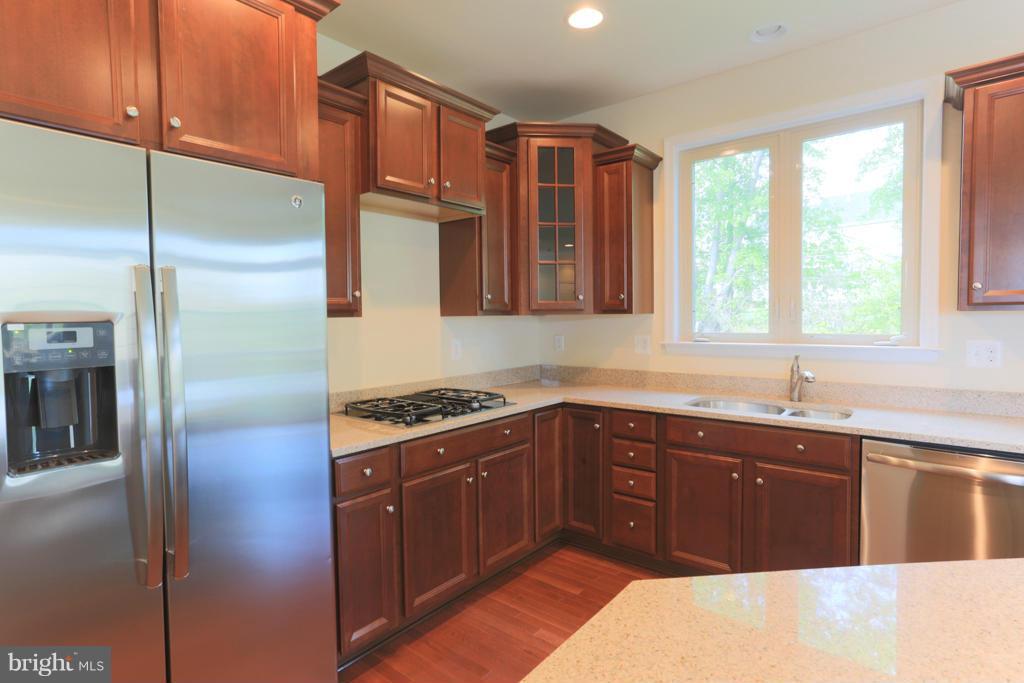 4410 Pensel Road Perry Hall, MD 21128 - Photo 11 of 30 a kitchen with stainless steel appliances granite countertop a refrigerator a sink a stove and a refrigerator