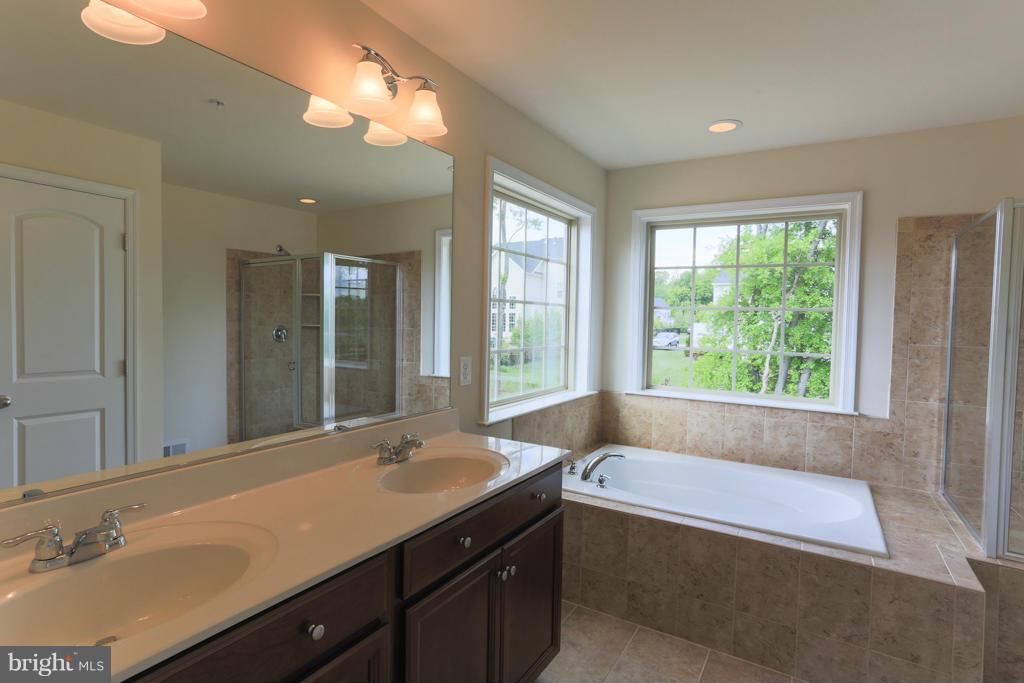 4410 Pensel Road Perry Hall, MD 21128 - Photo 25 of 30 a bathroom with a tub sink and mirror