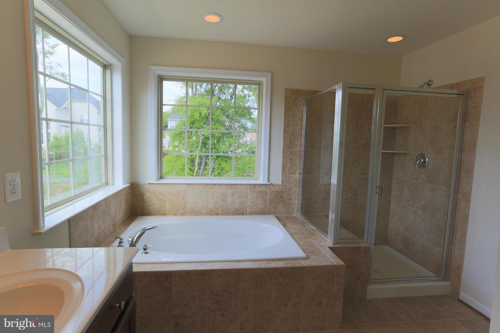 4410 Pensel Road Perry Hall, MD 21128 - Photo 26 of 30 a bathroom with a granite countertop sink and a bathtub