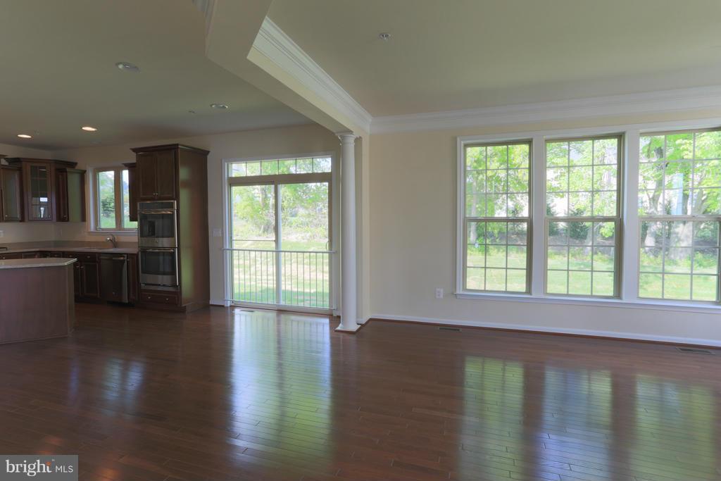4410 Pensel Road Perry Hall, MD 21128 - Photo 7 of 30 a view of a kitchen and an empty room with wooden floor and a window