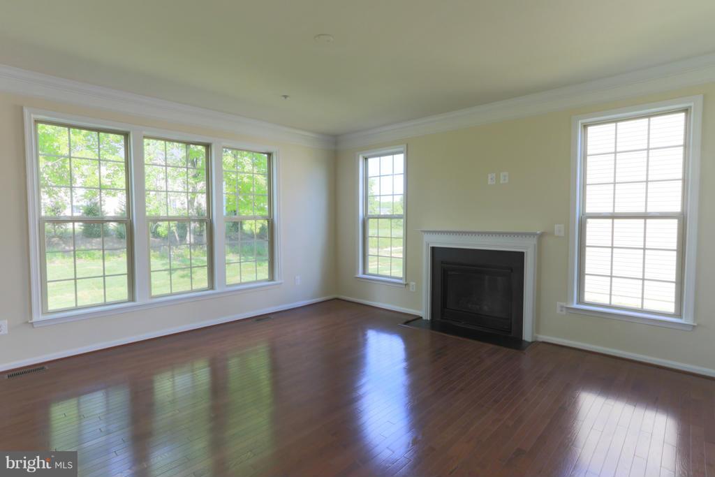 4410 Pensel Road Perry Hall, MD 21128 - Photo 8 of 30 a view of an empty room with wooden floor and a window