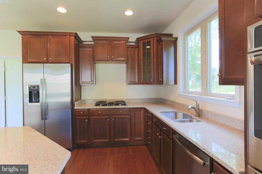 4410 Pensel Road Perry Hall, MD 21128 - Photo 10 of 30 a kitchen with stainless steel appliances granite countertop a sink stove and refrigerator