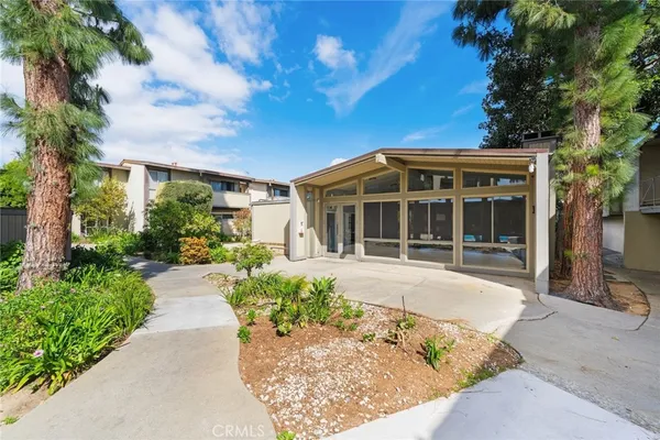 a front view of a house with a yard outdoor seating and barbeque oven