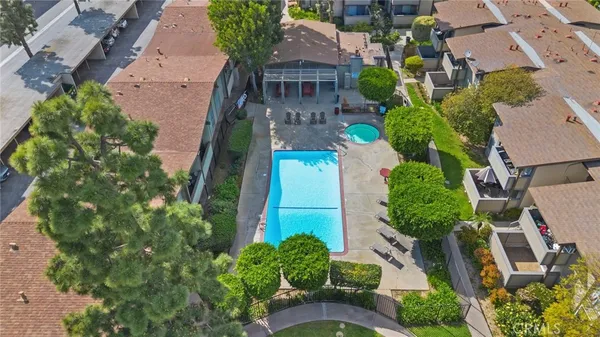 an aerial view of a house with a yard and parking space