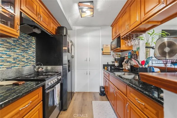 a kitchen with stainless steel appliances granite countertop a stove and a sink