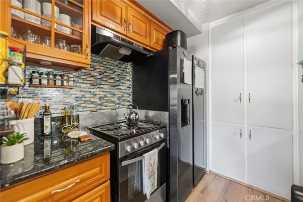 a kitchen with stainless steel appliances granite countertop a stove and a refrigerator