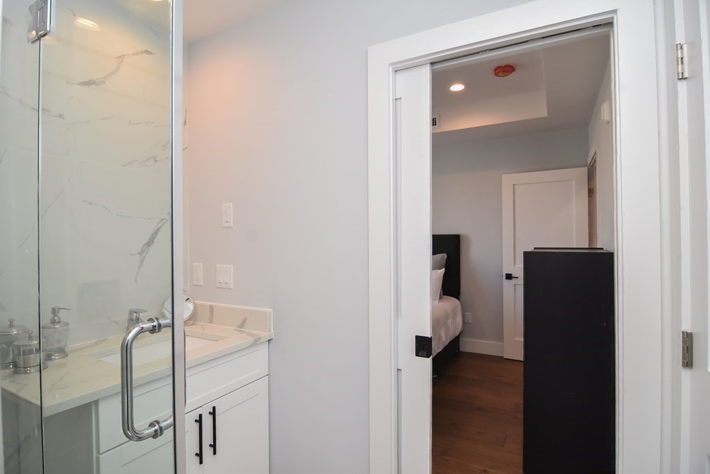 3850 Washington Street, Unit 1 Boston, MA 02131 - Photo 16 of 23 a room with a walk in closet and bathroom