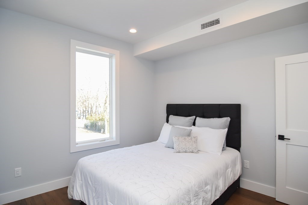 3850 Washington Street, Unit 1 Boston, MA 02131 - Photo 20 of 23 a bedroom with a bed and window