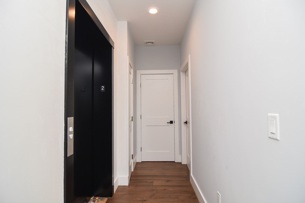 3850 Washington Street, Unit 1 Boston, MA 02131 - Photo 3 of 23 a view of a hallway with wooden floor