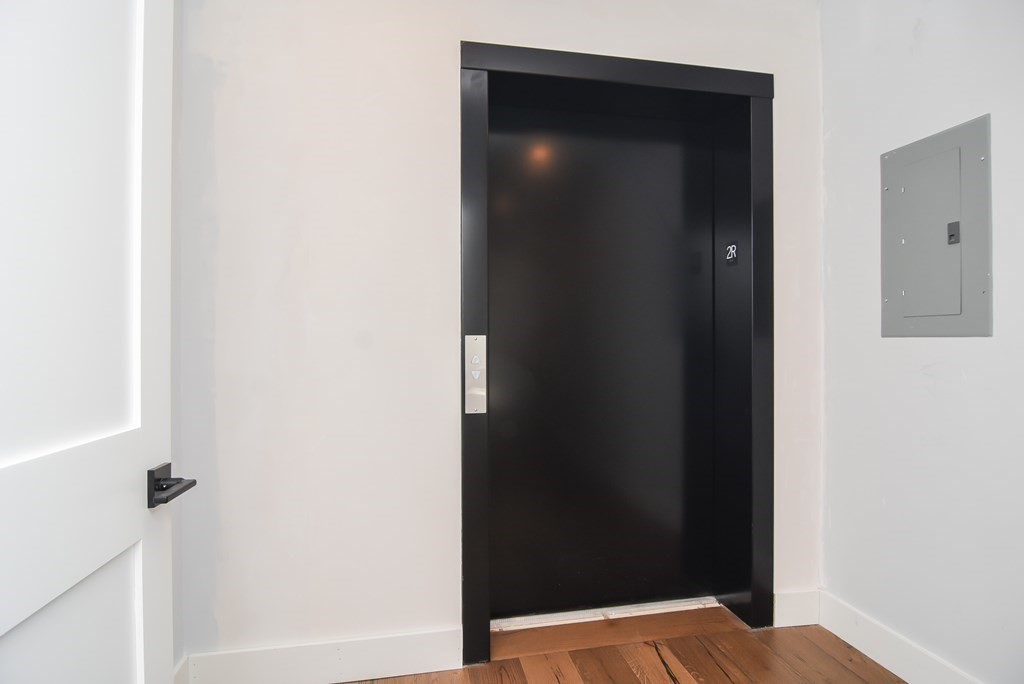 3850 Washington Street, Unit 1 Boston, MA 02131 - Photo 4 of 23 a small space with a wooden cabinets