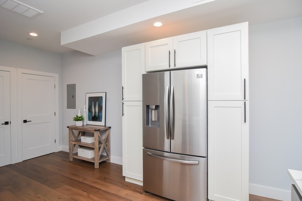 3850 Washington Street, Unit 1 Boston, MA 02131 - Photo 7 of 23 a metallic refrigerator freezer sitting in a kitchen