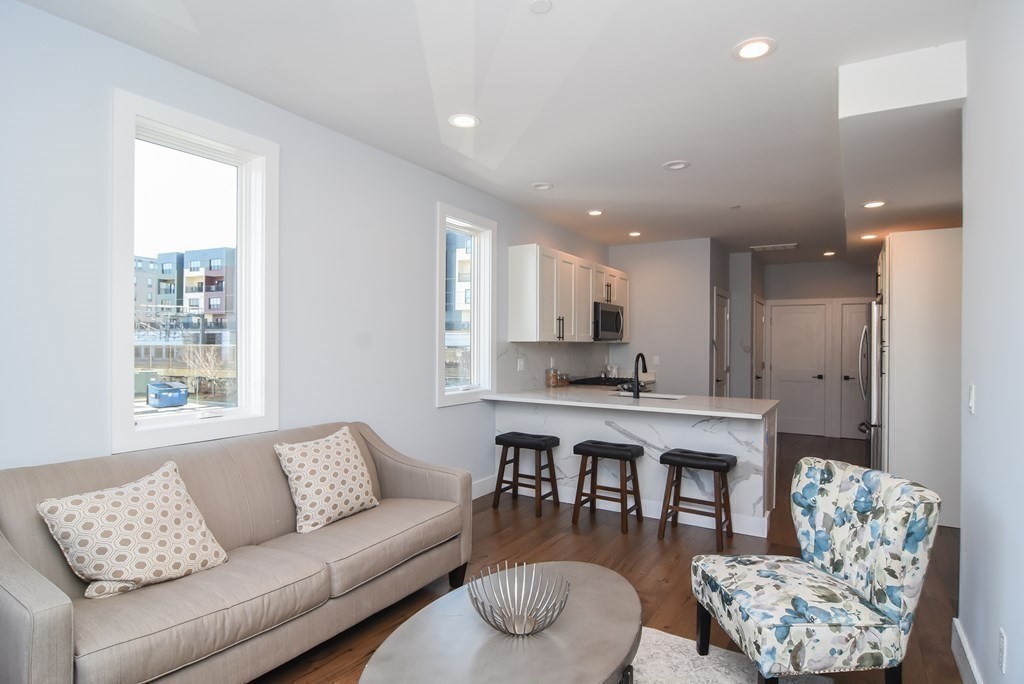 3850 Washington Street, Unit 1 Boston, MA 02131 - Photo 9 of 23 a living room with furniture kitchen view and a window