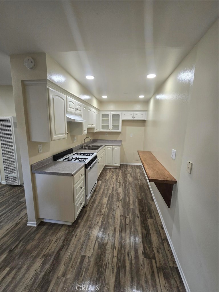 220 12th Street, Unit 8 Huntington Beach, CA 92648 - Photo 1 of 10 a kitchen with a sink and wooden floor