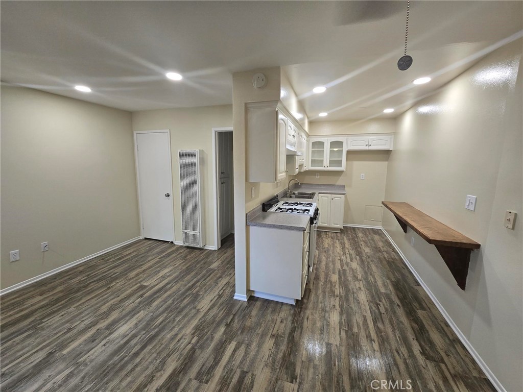 220 12th Street, Unit 8 Huntington Beach, CA 92648 - Photo 2 of 10 a view of kitchen and utility room with wooden floor