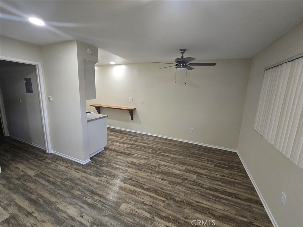 220 12th Street, Unit 8 Huntington Beach, CA 92648 - Photo 3 of 10 wooden floor in an empty room with a window