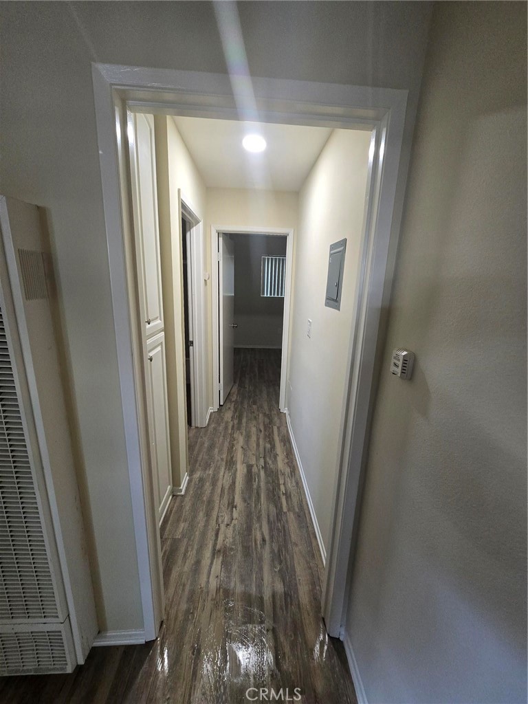 220 12th Street, Unit 8 Huntington Beach, CA 92648 - Photo 5 of 10 a view of a hallway with wooden floor and staircase