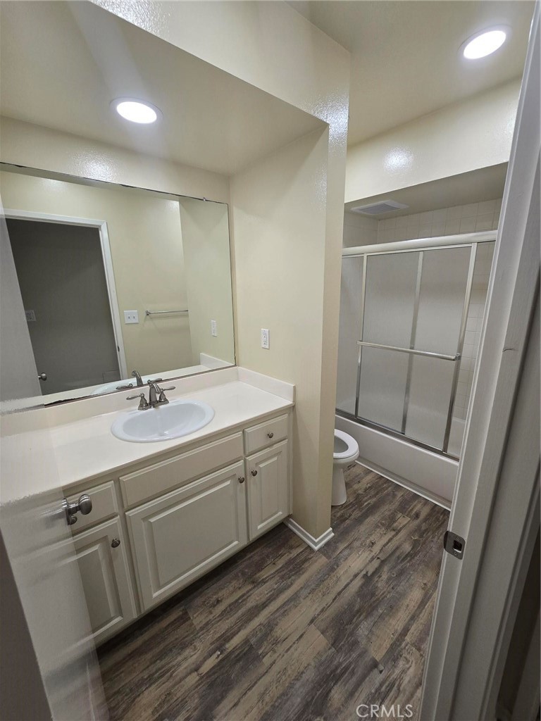 220 12th Street, Unit 8 Huntington Beach, CA 92648 - Photo 8 of 10 a bathroom with a double vanity sink and mirror