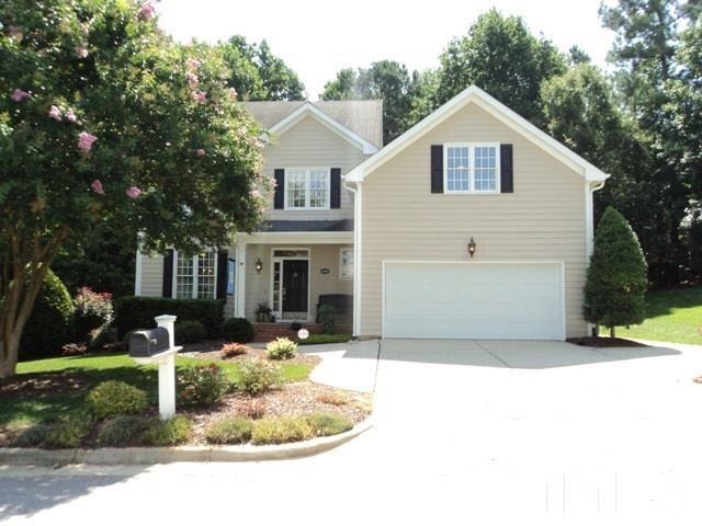 6900 Wilderness Road Raleigh, NC 27613 - Photo 1 of 25 a front view of a house with a yard