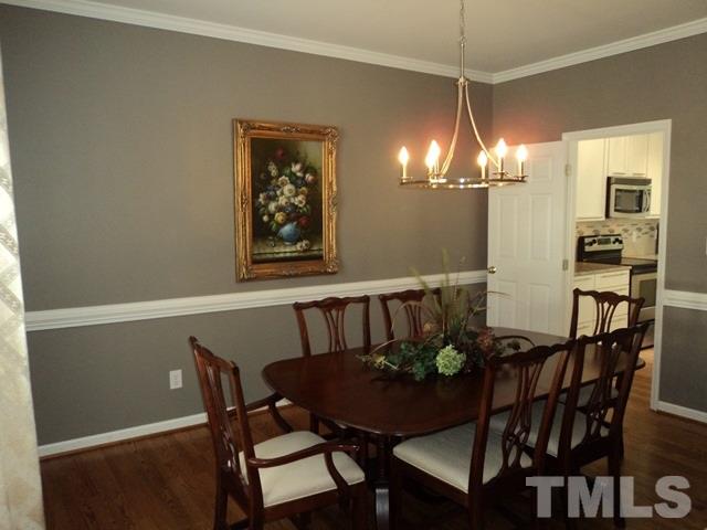 6900 Wilderness Road Raleigh, NC 27613 - Photo 2 of 25 a view of a dining room with furniture and chandelier