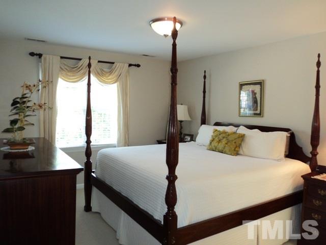 6900 Wilderness Road Raleigh, NC 27613 - Photo 11 of 25 a bedroom with a bed and a window