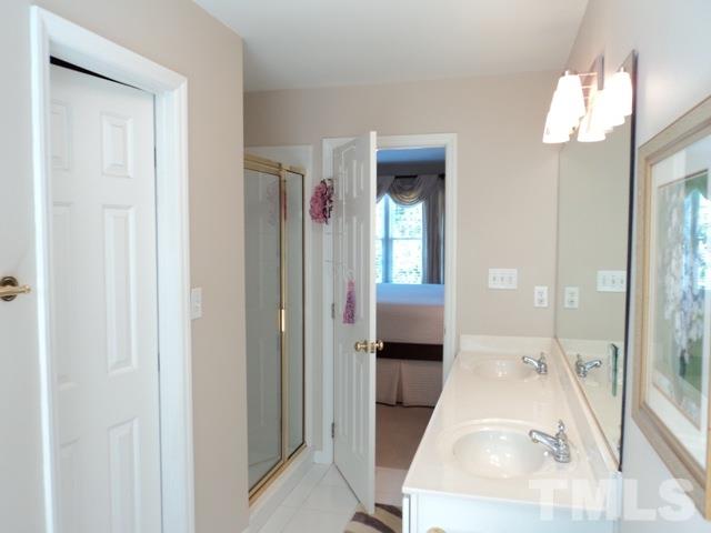 6900 Wilderness Road Raleigh, NC 27613 - Photo 14 of 25 a view of a bathroom with sink mirror and bathtub