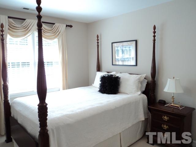 6900 Wilderness Road Raleigh, NC 27613 - Photo 15 of 25 a bedroom with a bed and a window